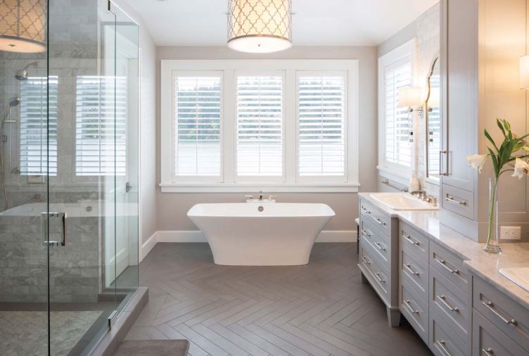 The herringbone motif from the dining room and breakfast nook is carried into the master bathroom, but here, it’s found on the floor rather than the wall. Symmetrical design principles carry through even to the more functional components of the home, like the shower and storage areas.
