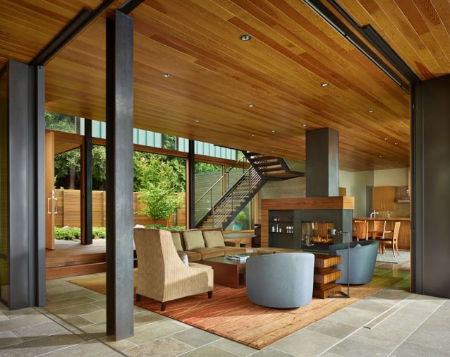 A courtyard defines the first of several spaces leading to the lake. Contrasting finishes differentiate the various wood species. Windows were supplied by Sierra Pacific Windows.