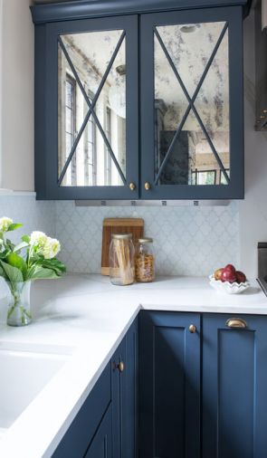 Glossy countertops, distressed mirrors on upper cabinets.