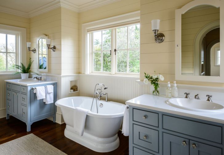 The same cabinetry used in the kitchen is reprised in the bathroom, lightened with furniture legs.