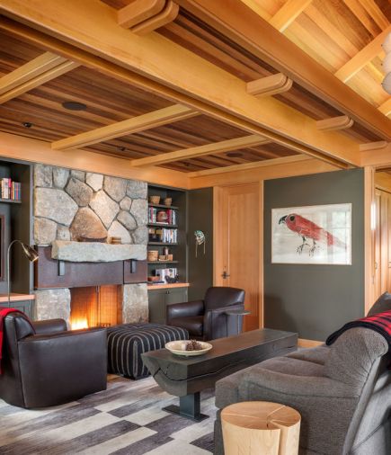 Doug designed a custom interior fireplace incorporating local fieldstone and a steel and I-beam mantle. An eclectic mix of furniture is tied together with cool grey tones, simple lines, and an emphasis on natural materials like leather and wood. Throws showcase classic Filson plaid.