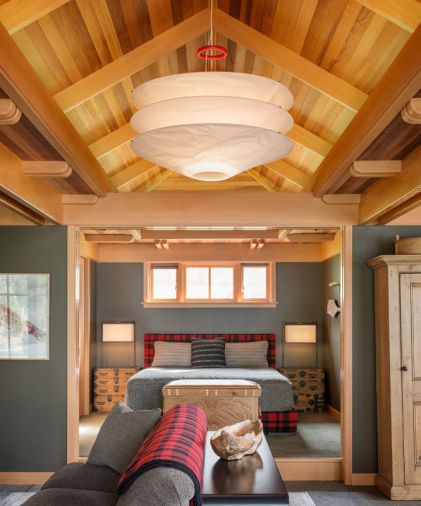 A light fixture from Ingo Maurer channels a Japanese design sensibility, while that classic Filson plaid makes another appearance on the bed’s headboard and box spring surround. Careful symmetry gives the interior a calm, harmonious feel.