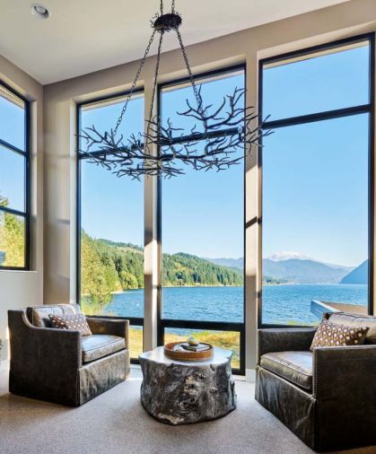 A spectacular Rainforest Chandelier by Currey & Co frames the view, below are swivel-style leather waterfall chairs by GHID.