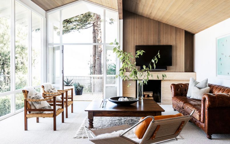 The remodel retained many of the classic midcentury components of the home, like an offset fireplace and the wood paneled ceiling.