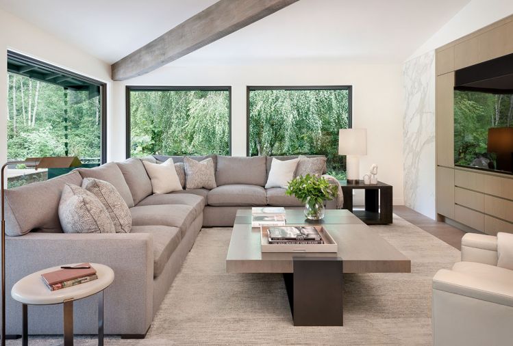 Adding to the neutral-but-comfortable vibe, the formal living room’s sectional and lounge chair are from A. Rudin, with fabric by Holly Hunt, coffee table by LUMA, side tables from Restoration Hardware and Elan Atelier, and rug from Stacey Logan.