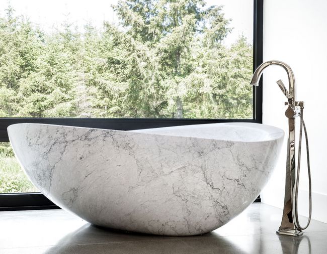 A marble Papillon Stone Forest bathtub with Brizo Virage Tub Filler adds soft lines to master bath. 