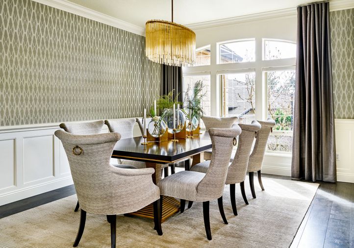 Although no structural changes were made to the dining room, the interior design decisions altered it dramatically: Wallquest Modern Elegance wallpaper that crowns the original classic wainscoting; replacing a traditional wedding cake chandelier with an elegant oval Arteriors chandelier to become the icing on this cake.