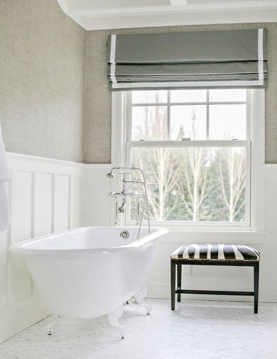 A claw-foot tub and zebra stool bring old world elegance to a first floor full bath.