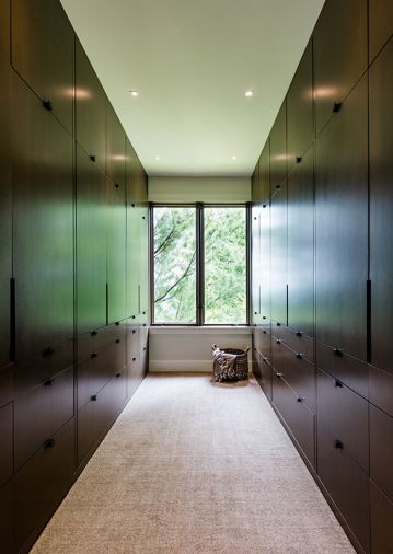 To maintain visual flow from room-to-room, warm Douglas fir wood with custom stain was used on the newly crafted master closet, with hanging space above and drawers below – for a tidier, clutter-free look.