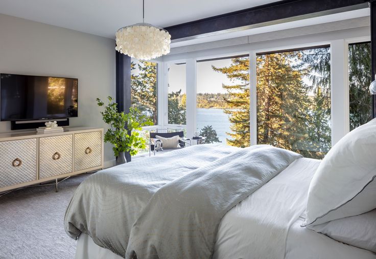 Master bedroom features energy efficient Sierra Pacific windows and doors opening onto Moon’s desired treehouse effect.