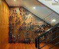 aneled glassed-in wine cellar nestles beneath entry staircase, with raised walnut floor and imported pegs.