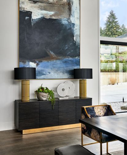 When the homeowners requested 11' ceilings instead of the standard 10' ones, Benedetti met the challenging job of adding an extra foot. Left Bank original artwork grounded by black Sunpan chest warmed with brass kickplate. Brass-based lamps reiterate theme.