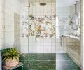 In the primary bathroom, gorgeous Tilebar tile in the shower provides a focal point, with Mission Stone Tile on the floor. Rowland turned the challenge of a vanity under the windows into a striking design moment, with suspended mirrors and pendants above the Pental counter.