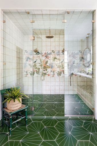 In the primary bathroom, gorgeous Tilebar tile in the shower provides a focal point, with Mission Stone Tile on the floor. Rowland turned the challenge of a vanity under the windows into a striking design moment, with suspended mirrors and pendants above the Pental counter.