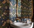 Rowland added a powder bath and ensconced the walls in Morris & Co wallpaper, from Kelly Forslund at the Seattle Design Center. A Signature Hardware sink and faucet, are joined by a Cooper Classics mirror and Visual Comfort sconce.