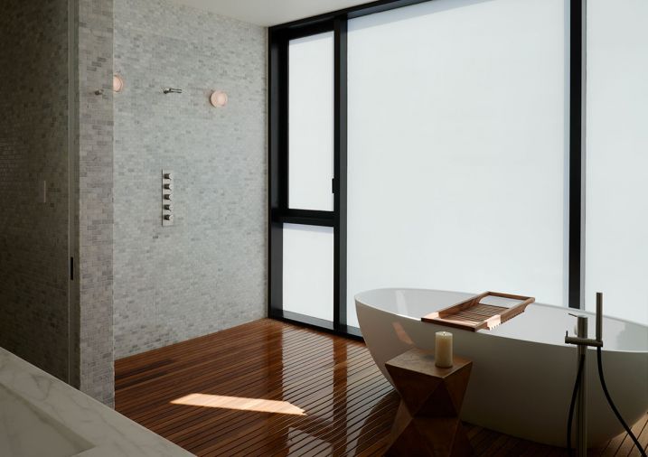 Frosted primary bath windows create intimate bathing in luxurious Boffi Fisher Island tub. Interceramic tumbled marble mosaic tile wall. Dornbracht shower system. RBW Crisp Light wall sconces. Teak deck.