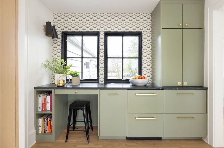 At the kitchen bar, Uni Mountain tile from Fireclay Tile covers the wall. The cabinetry, designed by Wise Design and built by Soren Clark of Owen Gabbert, LLC, is painted in ‘Treron’ from Farrow & Ball, and the honed Brazilian soapstone counter is from Classique Marble & Granite.