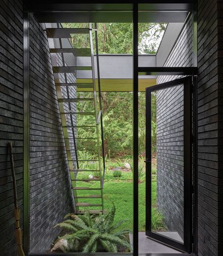 Black Norman-sized bricks with carbon black mortar from Mutual Materials whisper to mid-century design.