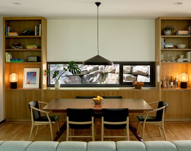 A window in the dining room provides a contrasting view, that of the rocky hillside.