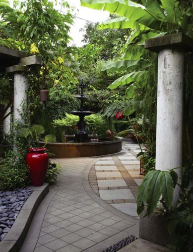 A three-story cast iron fountain is, in many ways, the garden’s centerpiece. Cast concrete, such as the fountain’s base and the tall columns, are one of the couple’s favorite materials. Hardy banana trees and other tropical plants overlook the area and provide shade and shelter.