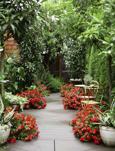 Fiery impatiens are the final touch to this creative, yet secluded, setting for small café-style tables.