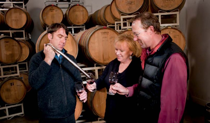 At Agate Ridge Winery owner Kim Kinderman and vineyard manager Jon Meadors get a barrel sample from winemaker Brian Denner.