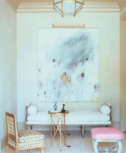 The furniture of Kasler’s own entryway may be antique but it is far from stuffy, with polka dots on the chair and pink leather on the stool – a color that reappears in other rooms in the home. The painting is by Steven Seinberg.