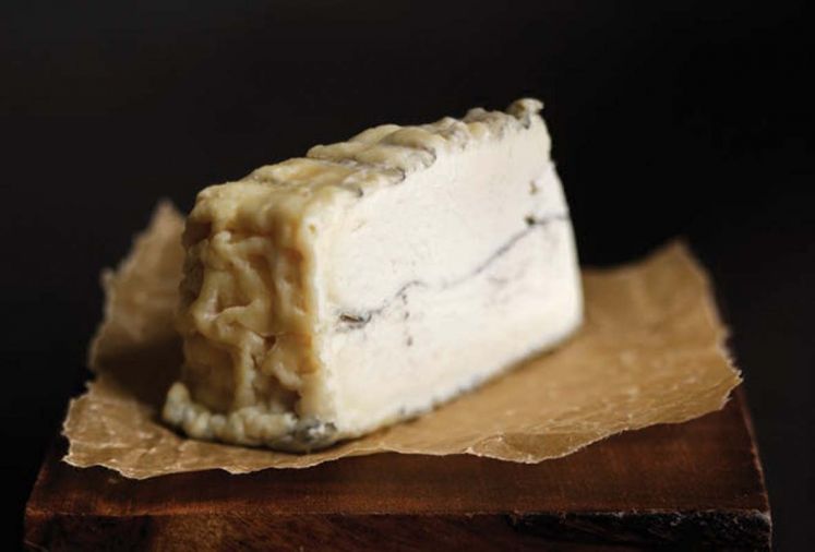 <strong>Dutchman’s Flat from Juniper Grove Farm</strong> is a mold-ripened chèvre in a 8” by 2” wheel. Its very delicate wrinkly rind covers a creamy interior and has an ashed exterior and center. It was named after the snow covered plain below Mt. Bachelor. Our wine pairing pick is a Buty White 2010 Columbia Valley.