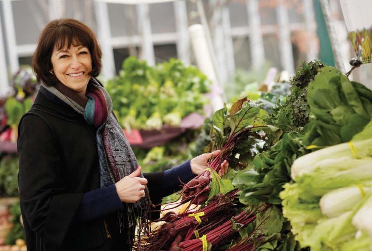 Diane Morgan, the author of <em>Roots: The Definitive Compendium</em>, shopping at the Portland Farmers Market.