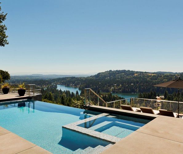 The infinity pool by Blue Mountain Pools, which includes a spa, overlooks the extraordinary view. Landscape design by Michael Schultz references nature's greenery seen throughout all four seasons. A few steps down from the pool, sunbathing on a quartet of chaise lounges can be enjoyed, once again facing the beautiful scenery.