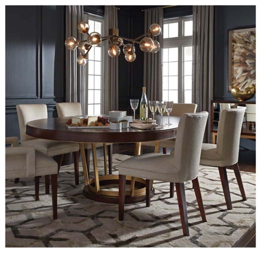 Crafted from warm walnut veneer and a satin-brass decorative pedestal base, the Delaney table from MGBW expands from a 60” round shape to a 80” oval, turning any dinner party into a special occasion.
