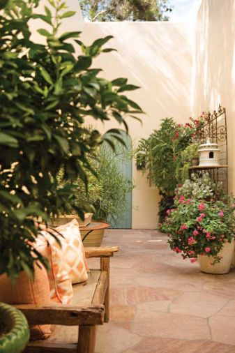 An enclosed courtyard graced with potted plants from Tony Michael in Portland opens to the main hall and the master bedroom.