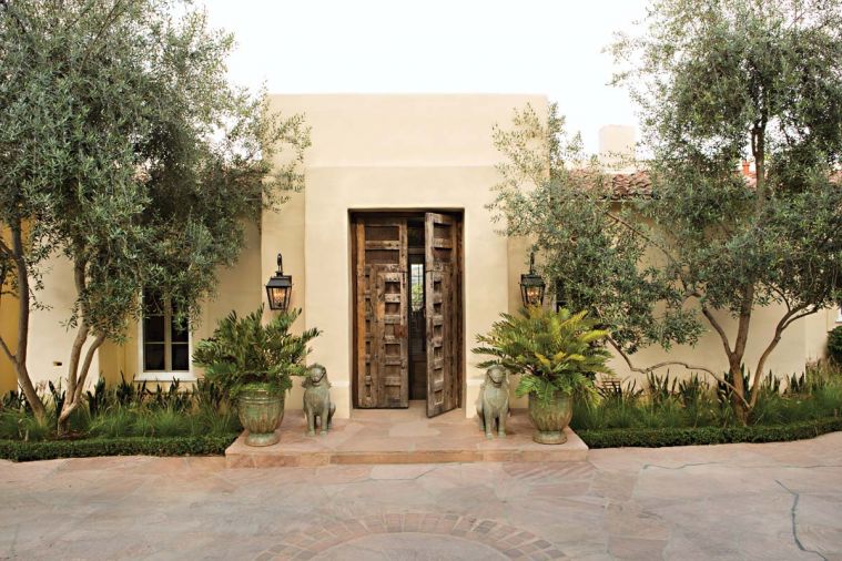 Joelle Nesen of Maison, Inc. transformed this 1997 So Cal estate built by home designers Bob and Jeff Holcombe for her long term Pacific Northwest clients. Her challenge was to marry their individual tastes into one harmonious vision for Southern California living. A pair of lofting olive trees embrace the entrance, where oversized antique Spanish wooden doors, guarded by a pair of antique bronze Cambodian Foo Dogs, purchased when the couple were married in Cambodia, open up a whole new world for the Northwest couple.