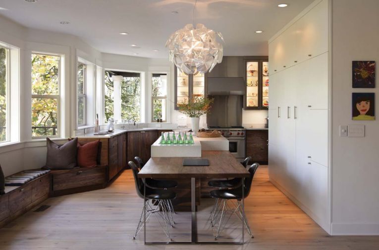 In this Portland kitchen designed by Barbara Sumner, the island’s horizontal bookmatched solid Western walnut from Crosscut Hardwood was used to ground the outer perimeter of the room. Sumner used walnut, quartz and stainless to unify the 16-foot-long island and seating area. Stainless steel legs were manufactured by Hanset Stainless, which also clad the cabinetry.