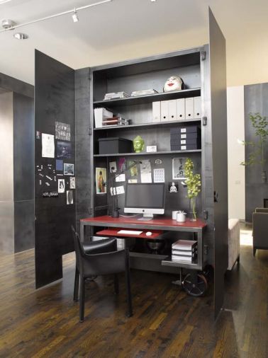 The custom home office sits on wheels and can be closed up and rolled out of the way on tracks set in the floor.