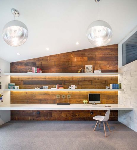A new home office was created from a garden storage area and seamlessly adopted into the home’s architectural design. Capitalizing on the rest of the structure’s mid-century elements, the space features streamlined shelving with integrated lighting, a PentalQuartz desktop and locally sourced barn wood that has found a second life as wall paneling.