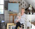 Diane in her upstairs studio with their fox terrier Lily.