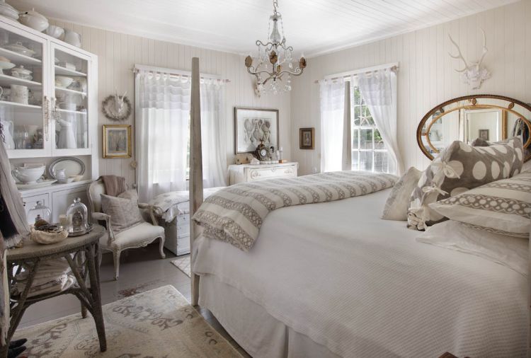 Relaxing shades of white, off-white and soft grays make the master bedroom a soothing retreat. The antique sea grass table reiterates the painted warm gray fir floors. V-groove walls and ceilings are original, and repainted. Bedding is from Sesame + Lilies.