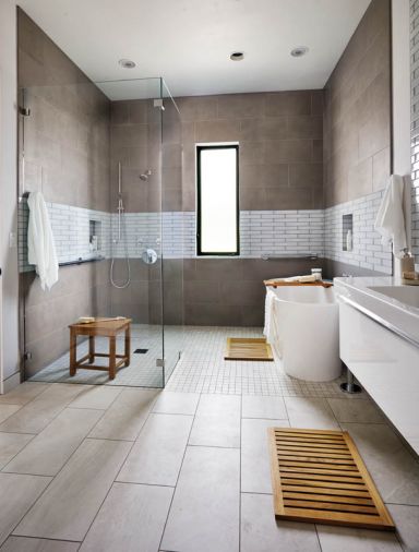 “A guest bathroom was designed initially for the grandparents,” says Hullinger, “we created a wet type spa space with grab bars, and all kinds of blocking in the walls. A band of porcelain tile wraps to the tub area.” Vanity by Villeroy Boch - shower and Thasos tub by Aquabrass.