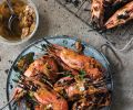Ox Restaurant’s Grilled Head-On Spot Prawns with Garlic, Green Onion and Sumac. “Grilling restaurant- worthy fish barely requires any preseasoning, skinning or shelling,” write Greg Denton and Gabrielle Quinonez Denton.