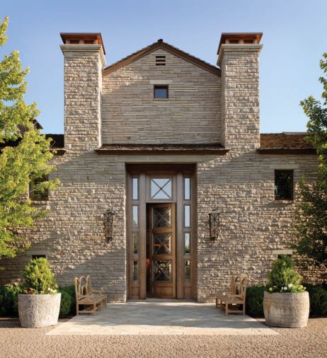 Four inch cobblestones from Ibison Stone of Oklahoma, which match the stone used in the home’s original façade, were placed in a fish scale fan pattern the whole length of the 1/4 mile long driveway. A large fountain was replaced with an exterior “tile carpet” that defines the entry. Sevigny built a temporary mezzanine to help finish carpenters and mason John Taylor, who installed the heavy stone fireplace blocks from China. Some of the stones were cut from water troughs in which well-worn rope holes used to tether animals are still visible.