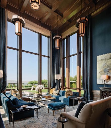 Blue jewel tones found in the Holly Hunt sateen sofas, India rep fabric walls and silk curtains enliven the living room. Rasar’s signature “Kenny G” sofa design sits on a Driscoll Robbins flat weave rug. Custom chandeliers camouflage recessed lighting.