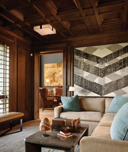 Richer tones and a darker color palette extend to the coffered walnut ceilings and custom lighting designed to aid the homeowner’s sensitivity to light in a bright climate. The inside backs of the wing back chairs in the adjacent living room feature embossed leather. Rasar recommended Romano create large shutters for room-to-room continuity. “We built them as a door with a louvered shutter inside it and carefully aligned the pieces to coordinate with the rest of the paneling,” says Romano.