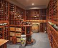 Ron Cowan of Stellar Cellars built the wine cellar with mold and mildew resistant African Sapele wood, featuring a peninsula with cascading bottles, individual bottle storage with cleats, diamond racking below - all held together with wooden dowels and glue for strength.