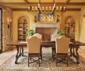 The dining room chandelier was designed by Hyde Evans, based on an antique. Sconce by Woodland Furniture. Antique stone fireplace from Chateau Domingue in Houston.