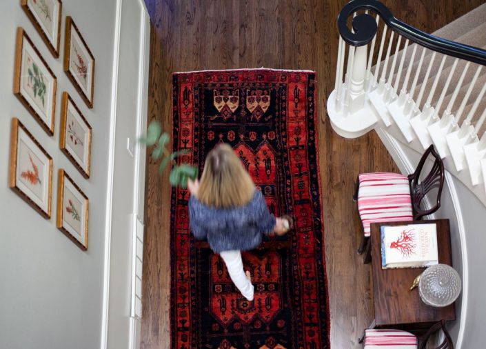 Warm oriental rugs are incorporated throughout the home. 
“I think that you need to layer,” says Gretchen. “You can’t just have everything new. And there’s nothing like an 
antique rug in a new space.”