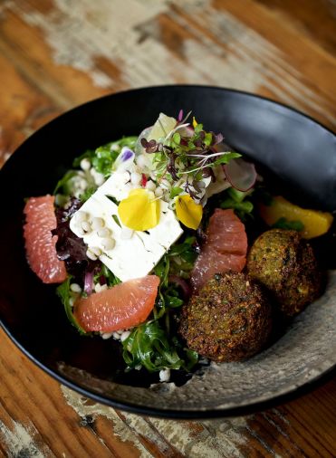 Freekeh Bowl with Chickpea Quinoa Fritters, Citrus, Young Lettuce, Feta, Charred Onion Crema
