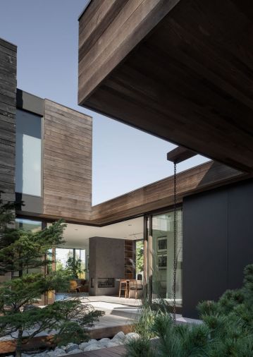 Extending the siding into the interior of the house creates a sense of continuity while drawing attention to the craftsmanship that went into the home. Planned sight lines take advantage of borrowed landscapes at the horizon. 
© Andrew Pogue