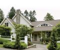 Why hide a house this charming behind a hedge? Privacy can be achieved in more subtle ways, like lowering the grade from the lane to the entry, and painting the fence white to clearly define the boundary. The winking eyebrow window watches when Liz works in her garden.