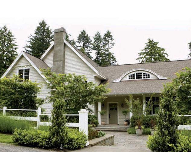 Why hide a house this charming behind a hedge? Privacy can be achieved in more subtle ways, like lowering the grade from the lane to the entry, and painting the fence white to clearly define the boundary. The winking eyebrow window watches when Liz works in her garden.